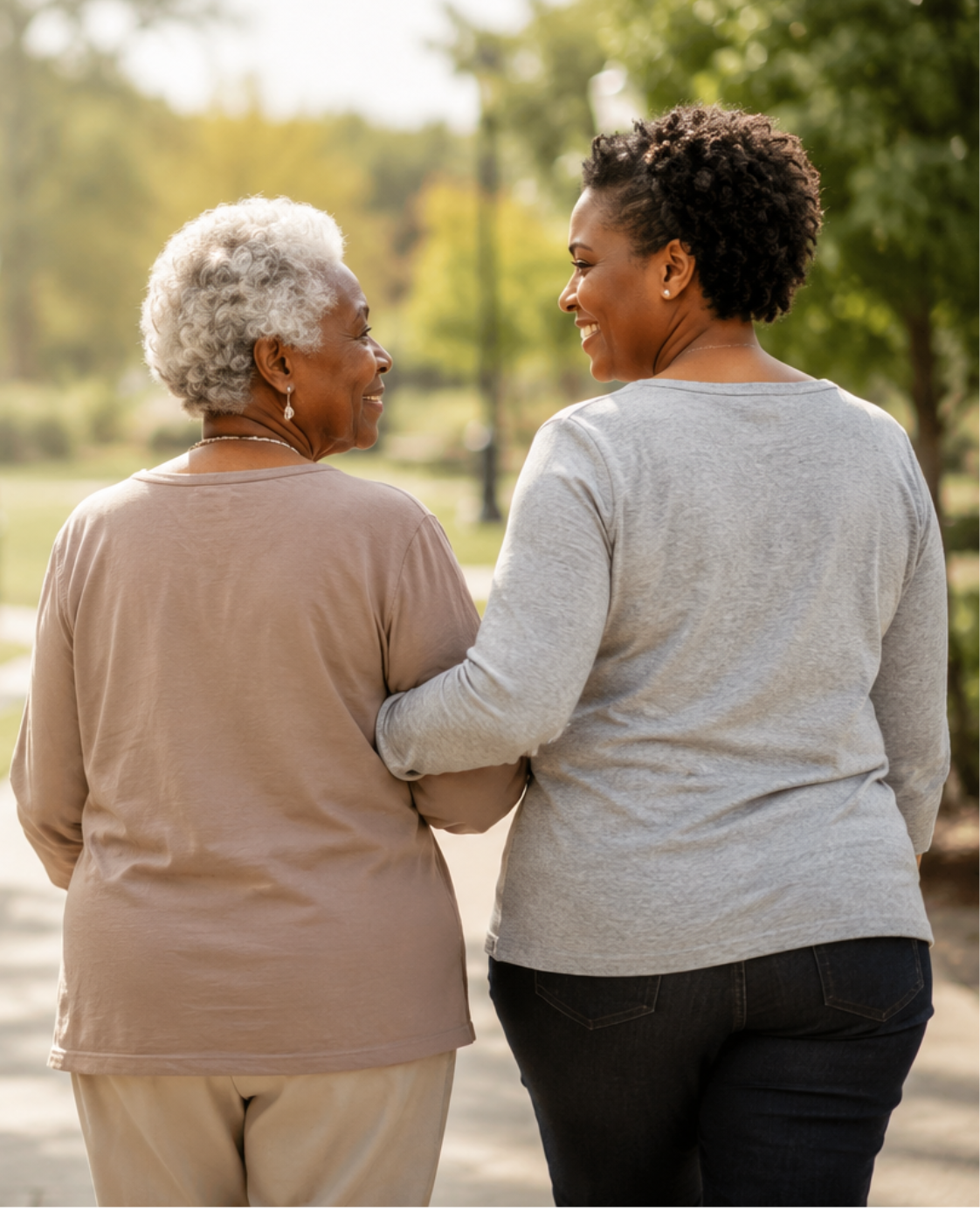 Mother and daughter walking together arm in arm in a park
